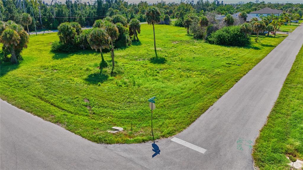 An aerial view of a vacant, grassy corner lot with several palm trees — 141 POMPANO STREET, PLACIDA, FL