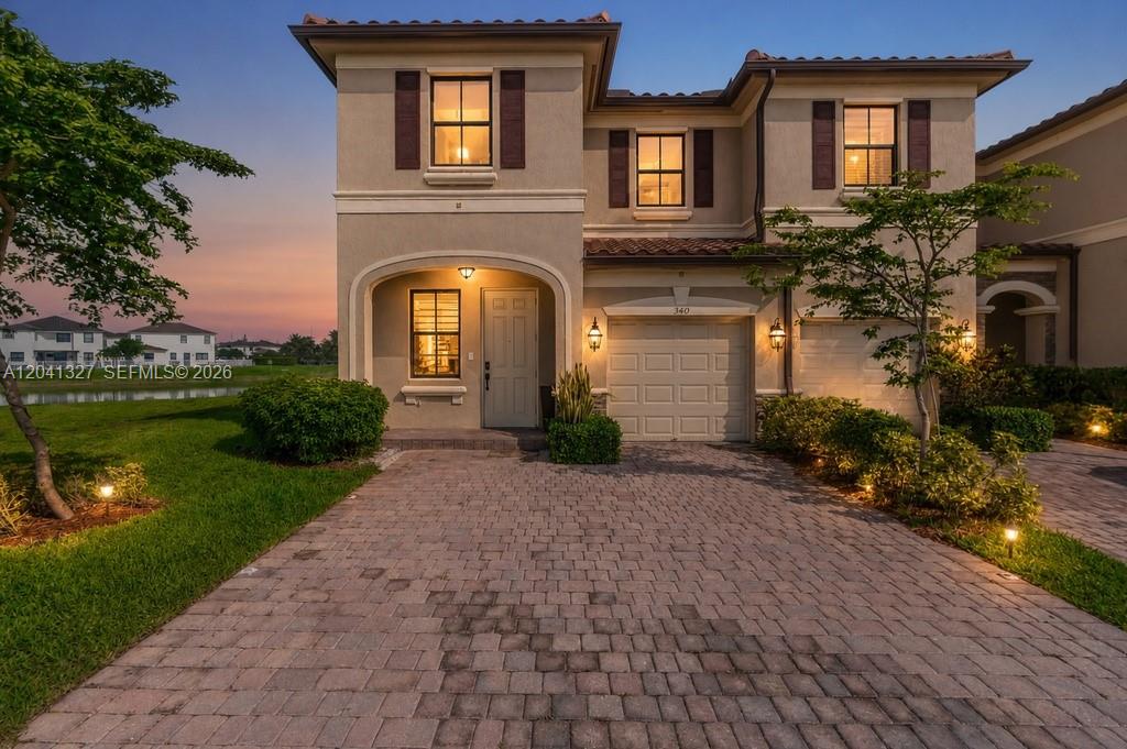 A two-story suburban house with a paved driveway, garage, and a small front yard — 3401 W 94th Ter, Hialeah FL 33018-2079, HIALEAH, FL