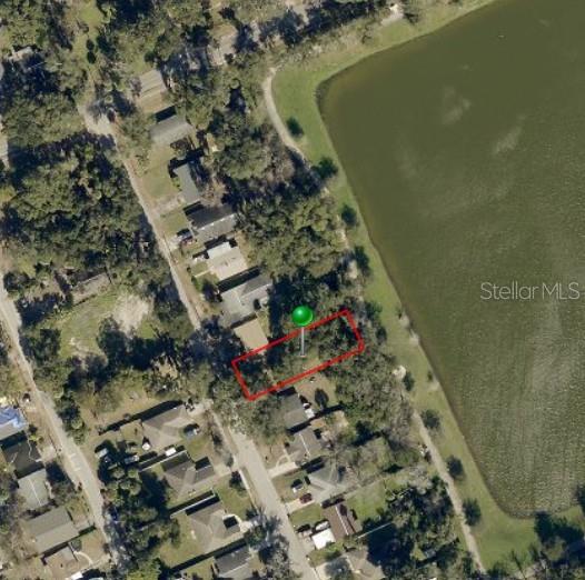 This is an aerial view of a rectangular vacant lot bordering a lake — 529 FULTON STREET, DAYTONA BEACH, FL