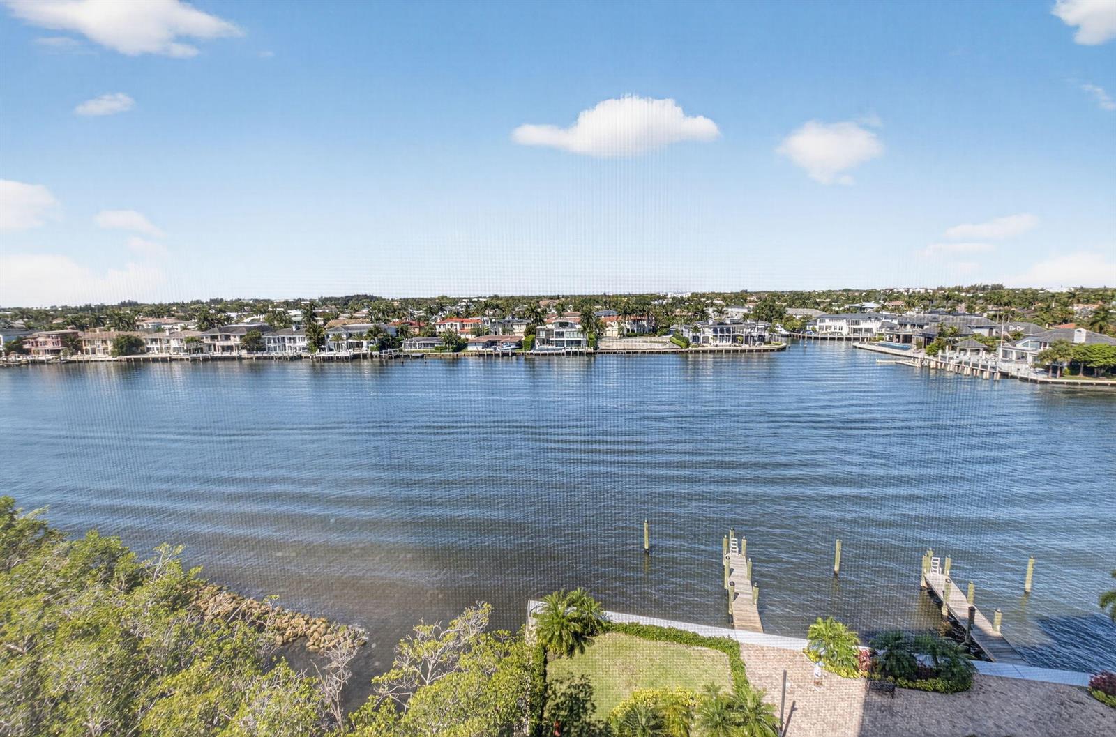 An elevated view of a wide waterway with docks and houses on the opposite shore — 3420 S Ocean Boulevard # 8z, Highland Beach FL 33487, HIGHLAND BEACH, FL