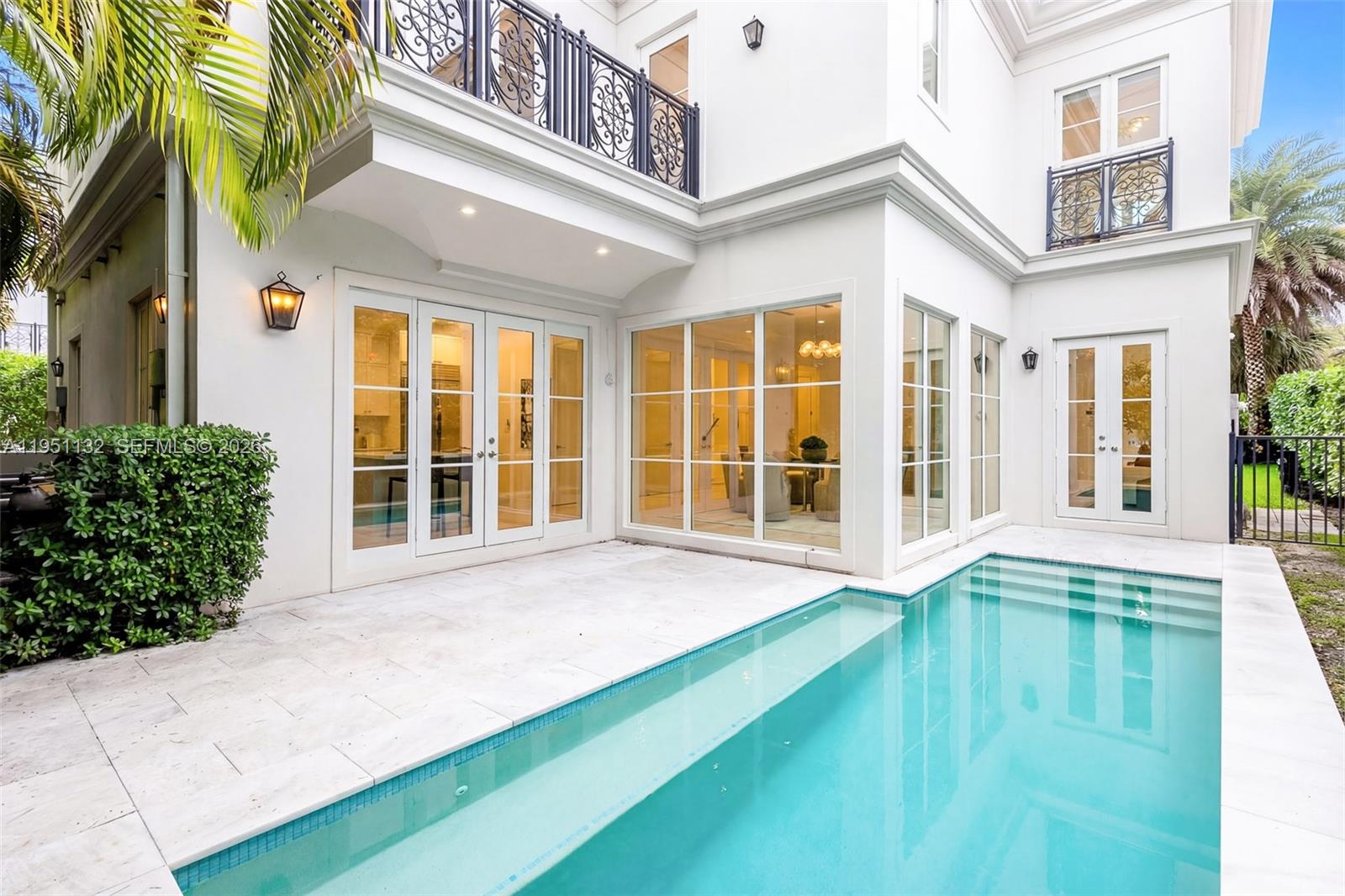 A white two-story house features a patio and a rectangular swimming pool — 315 Santander Ave # 315, Coral Gables FL 33134, CORAL GABLES, FL