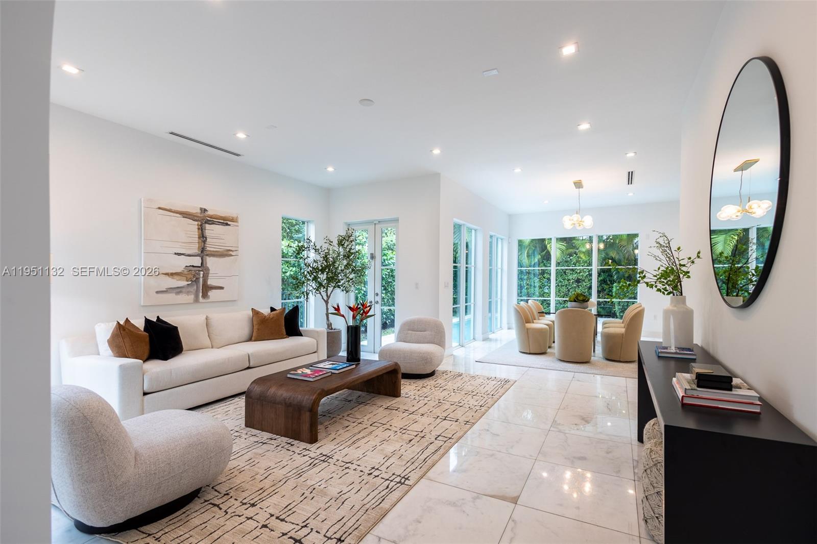 A bright living and dining area features white walls, marble floors, and modern furniture — 315 Santander Ave # 315, Coral Gables FL 33134, CORAL GABLES, FL