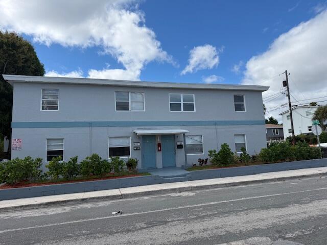 A two-story gray apartment building with a blue trim and a small front garden — 1913 Division Avenue, West Palm Beach FL 33407, WEST PALM BEACH, FL