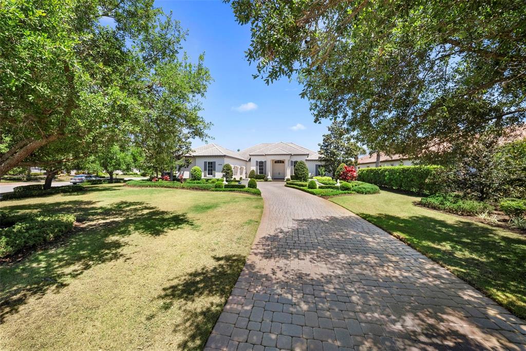 A paved driveway leads to the front entrance of a single-story house with landscaping — 16204 DAYSAILOR TRAIL, LAKEWOOD RANCH, FL