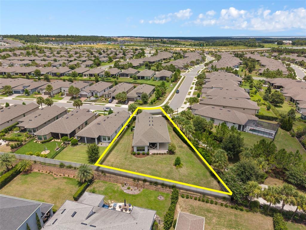An aerial view shows a single-story house on a large, triangular corner lot — 1357 ZEEK RIDGE STREET, CLERMONT, FL