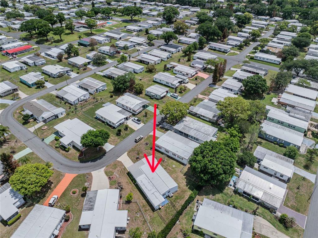 An aerial view shows a single-story mobile home with a red arrow pointing to it — 1610 REYNOLDS RD. UNIT 108, LAKELAND, FL