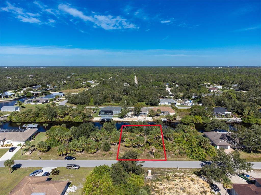 An aerial view shows a vacant, rectangular lot outlined in red along a residential street — 17340 GULFSPRAY CIRCLE, PORT CHARLOTTE, FL