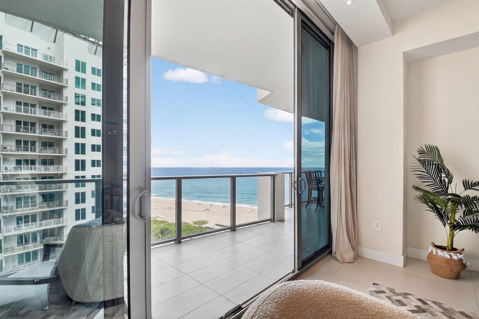 A room with a sliding glass door opening to a balcony overlooking the ocean — 3100 N Ocean Drive # H, Singer Island FL 33404, SINGER ISLAND, FL