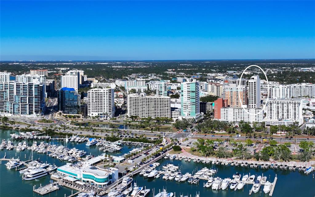 An aerial view shows a coastal city skyline with a marina in the foreground — 33 S PALM AVENUE UNIT 1501, SARASOTA, FL