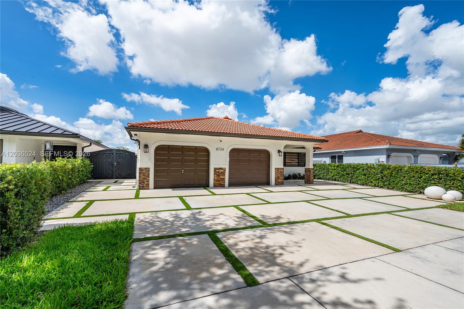 A single-story house with a two-car garage and a concrete paver driveway with grass strips — 8724 NW 149th Ter, Miami Lakes FL 33018, MIAMI LAKES, FL