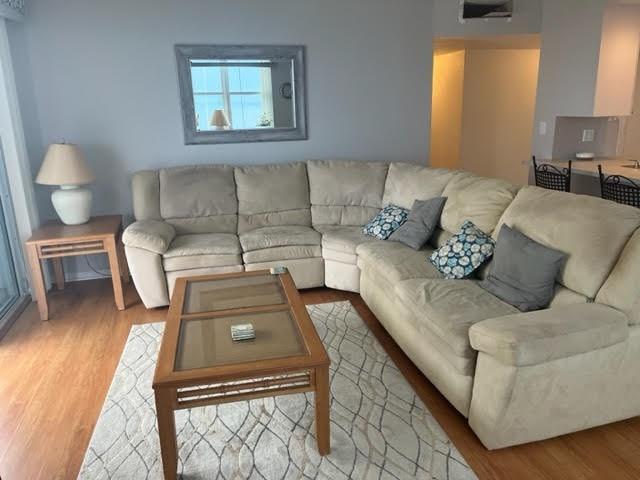 A living room features a beige sectional sofa, a glass-top coffee table, and a side table — 101 Briny Avenue # 2402, Pompano Beach FL 33062, POMPANO BEACH, FL