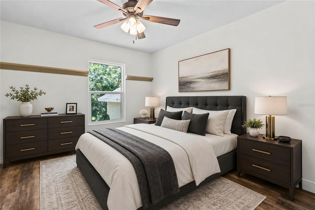 A bedroom features a dark upholstered bed, matching nightstands, a dresser, and a ceiling fan — 1744 NESTLEWOOD TRAIL, ORLANDO, FL