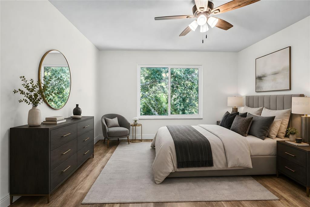 A bedroom features a bed, dresser, armchair, and ceiling fan on wood-look flooring — 1744 NESTLEWOOD TRAIL, ORLANDO, FL