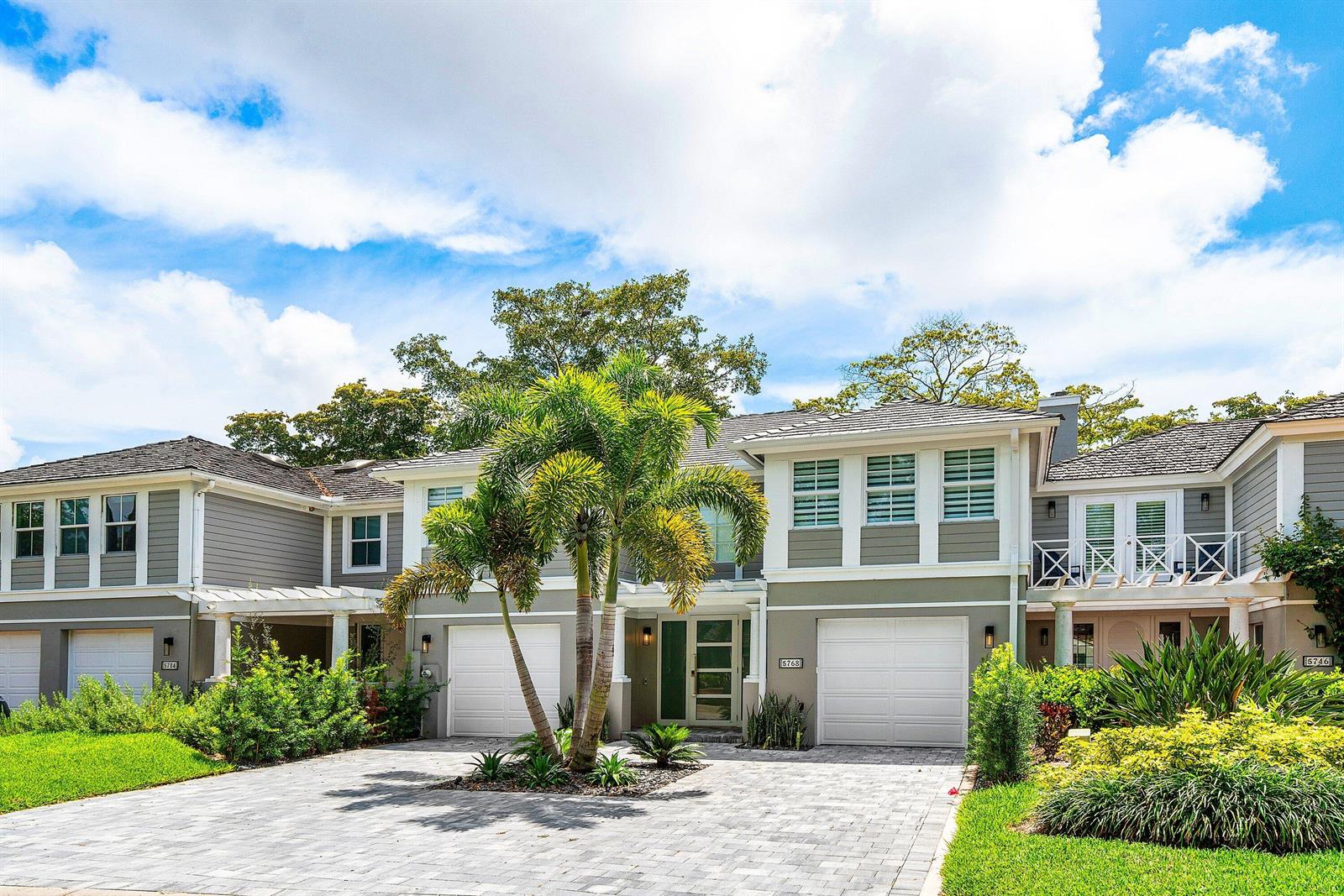 A two-story house with gray siding, a paved driveway, and a palm tree in front — 5768 NW 39th Avenue, Boca Raton FL 33496, BOCA RATON, FL