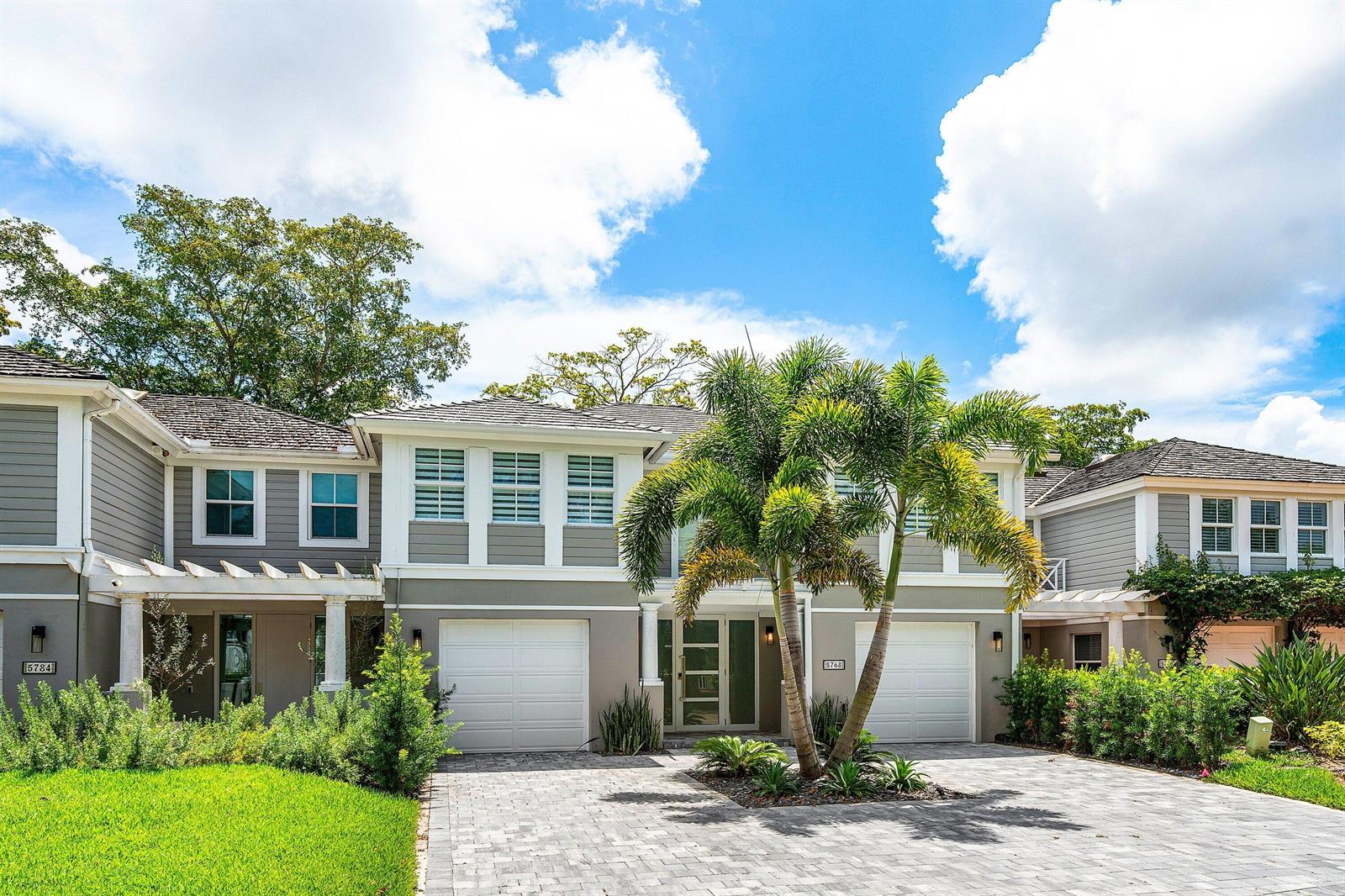 A two-story house with gray siding, white trim, two garages, and a palm tree out front — 5768 NW 39th Avenue, Boca Raton FL 33496, BOCA RATON, FL