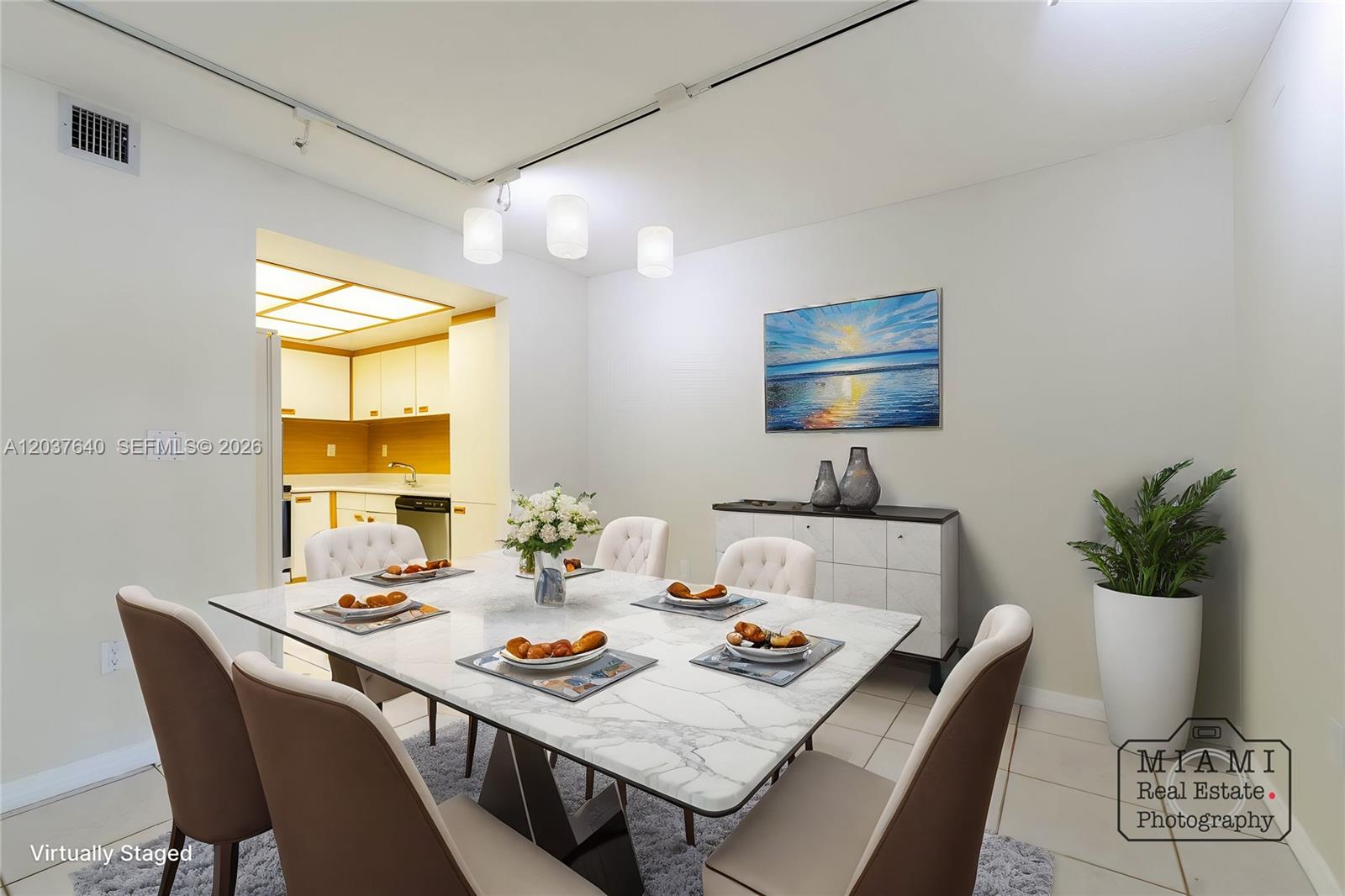 A dining room features a marble-topped table, six upholstered chairs, and a sideboard — 9015 SW 125th Ave # N207, Miami FL 33186, MIAMI, FL