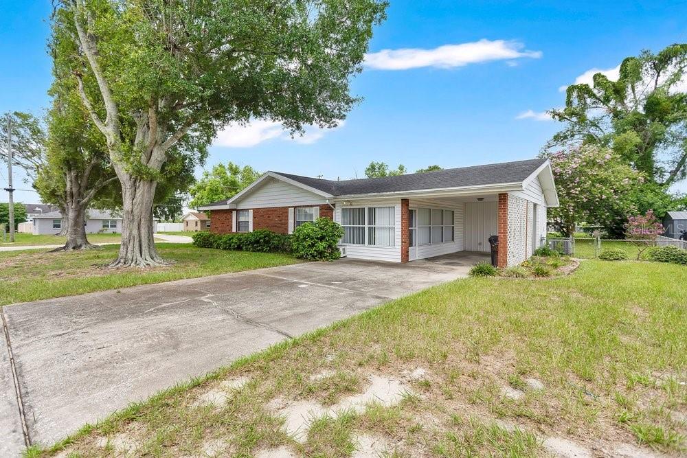 A single-story house with a brick and siding exterior, a concrete driveway, and a carport — 132 ANARECE AVENUE, AUBURNDALE, FL