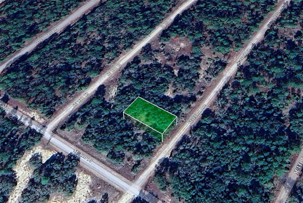 An aerial view shows a rectangular plot of land highlighted in green — Lot 31 SE 133RD, DUNNELLON, FL