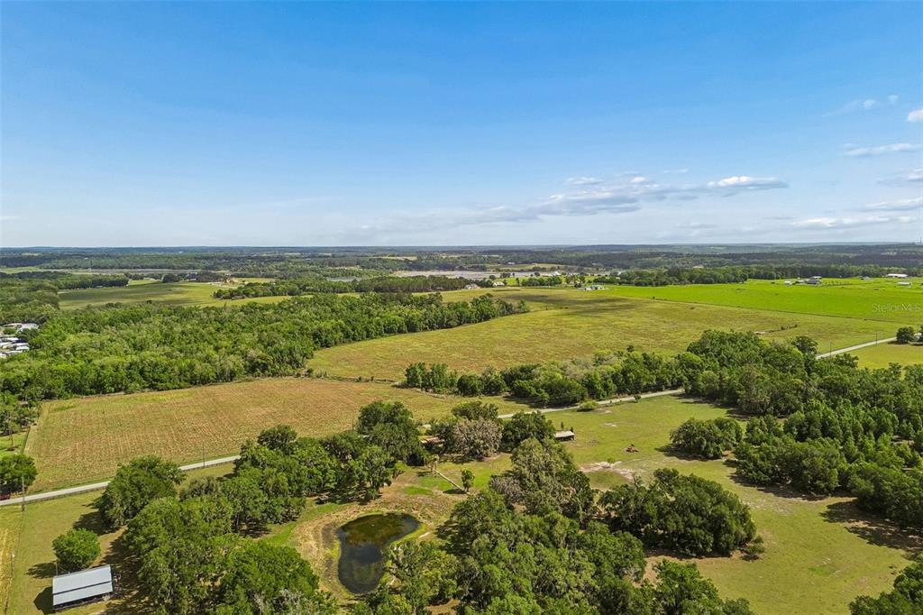 An aerial view shows a large rural property with fields, trees, and a small pond — BAYHEAD ROAD Lot 5-11, DADE CITY, FL