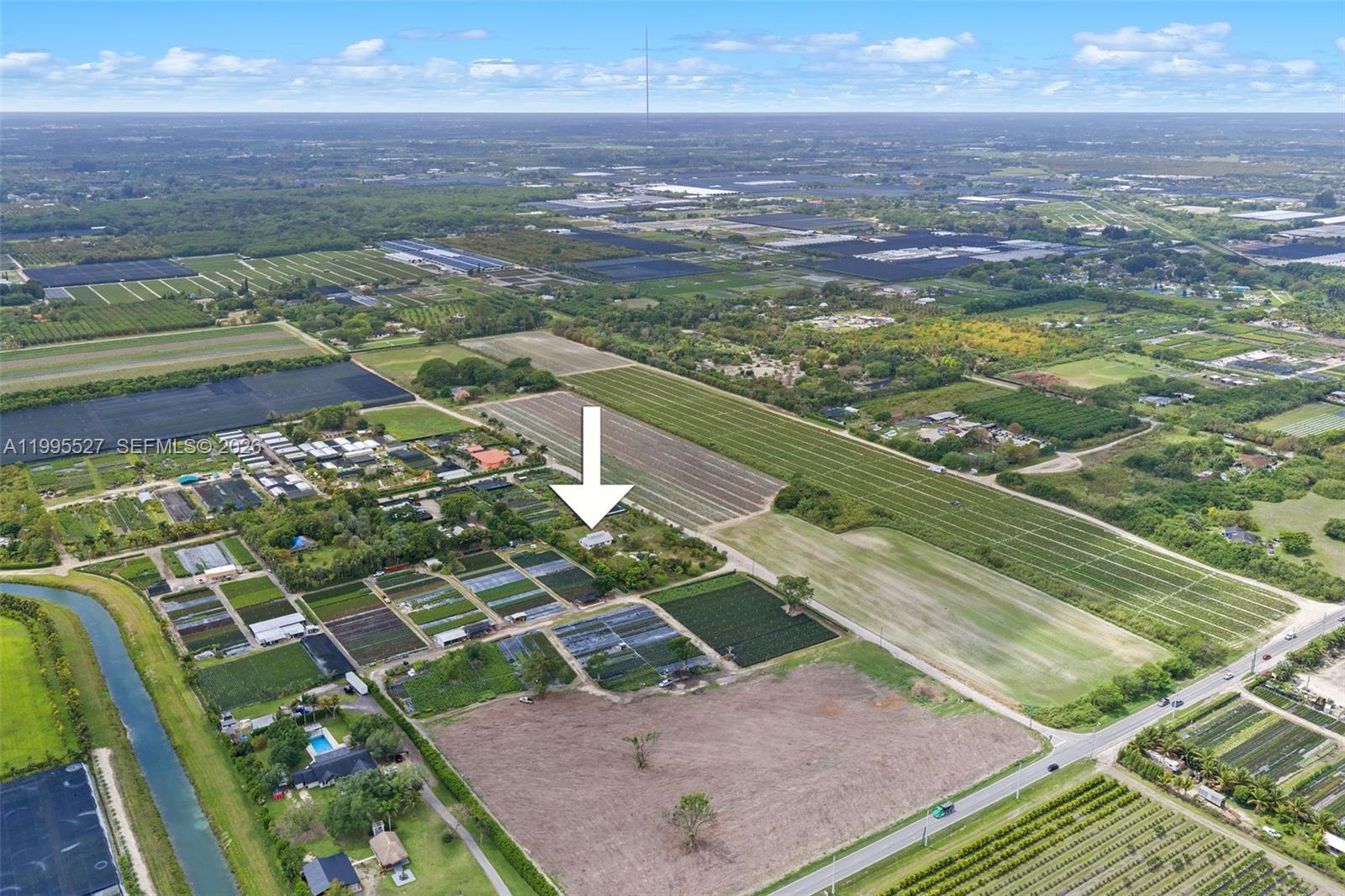An aerial view shows a rural property with a house, greenhouses, and surrounding farmland — 20255 SW 154th Ave, Miami FL 33187, MIAMI, FL
