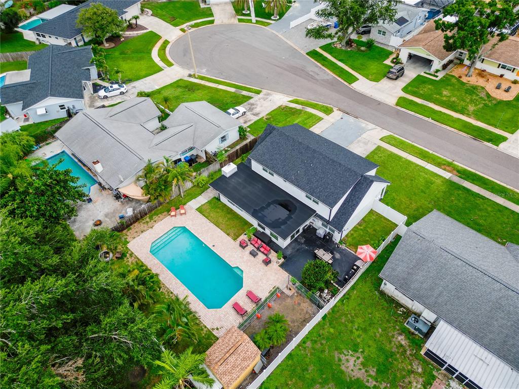 An aerial view shows a residential house with a pool, patio, and fenced backyard — 8407 QUARTZ PLACE, TAMPA, FL
