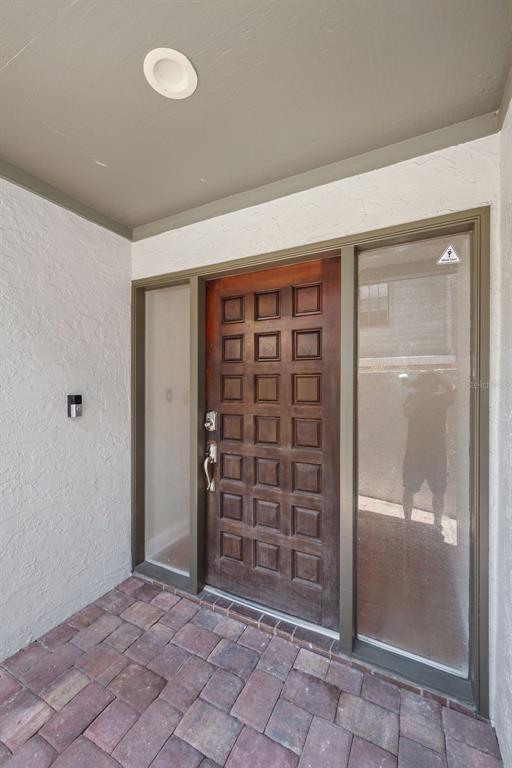 A wooden front door with a grid pattern is flanked by two glass sidelights — 4510 W FIG STREET UNIT C, TAMPA, FL