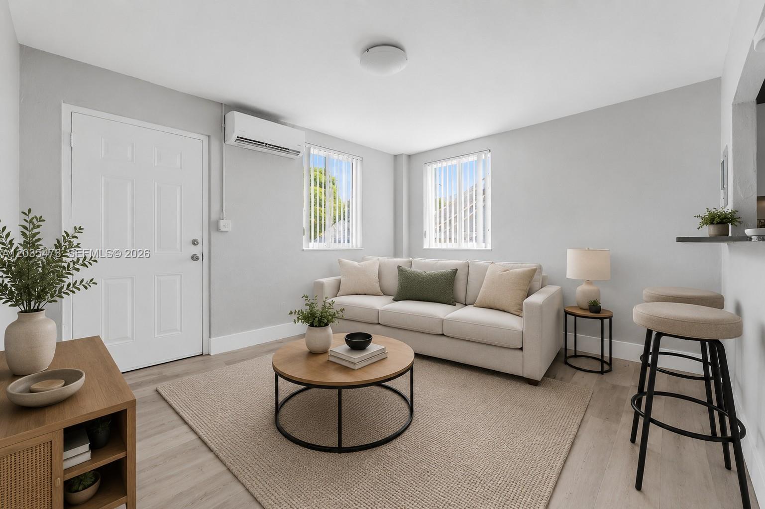 A living room features a beige sofa, a round coffee table, and a breakfast bar — 6647 SW 59th Pl # 101, South Miami FL 33143, SOUTH MIAMI, FL