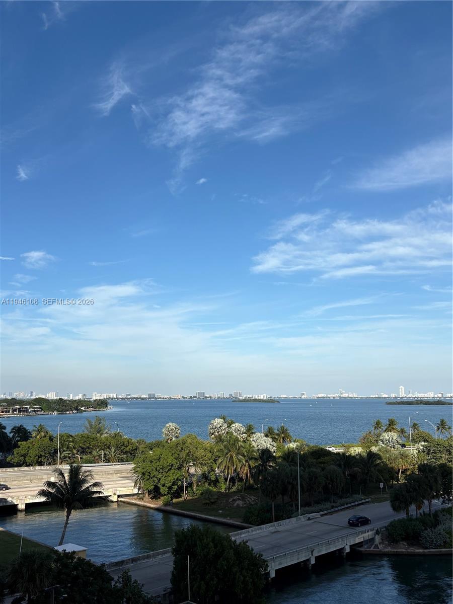 A high-angle view shows a body of water, a bridge, and distant city buildings — 600 NE 36th St # 714, Miami FL 33137, MIAMI, FL