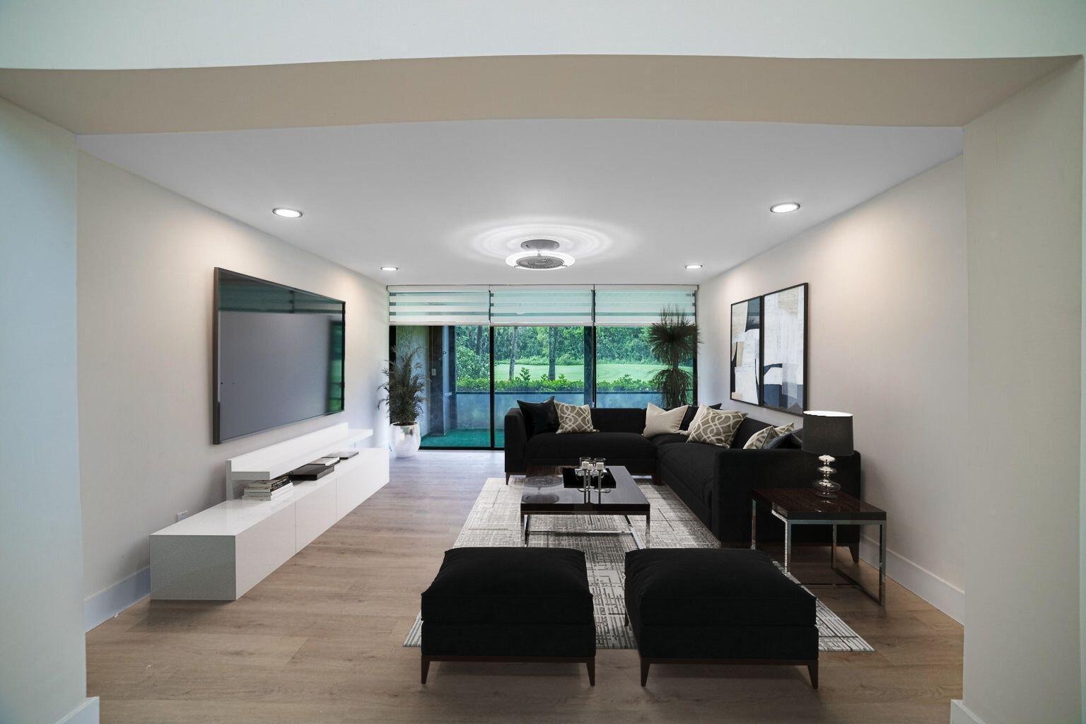 A modern living room features a large black sectional, white media console, and floor-to-ceiling windows — 8008 Eastlake Drive, Boca Raton FL 33433, BOCA RATON, FL