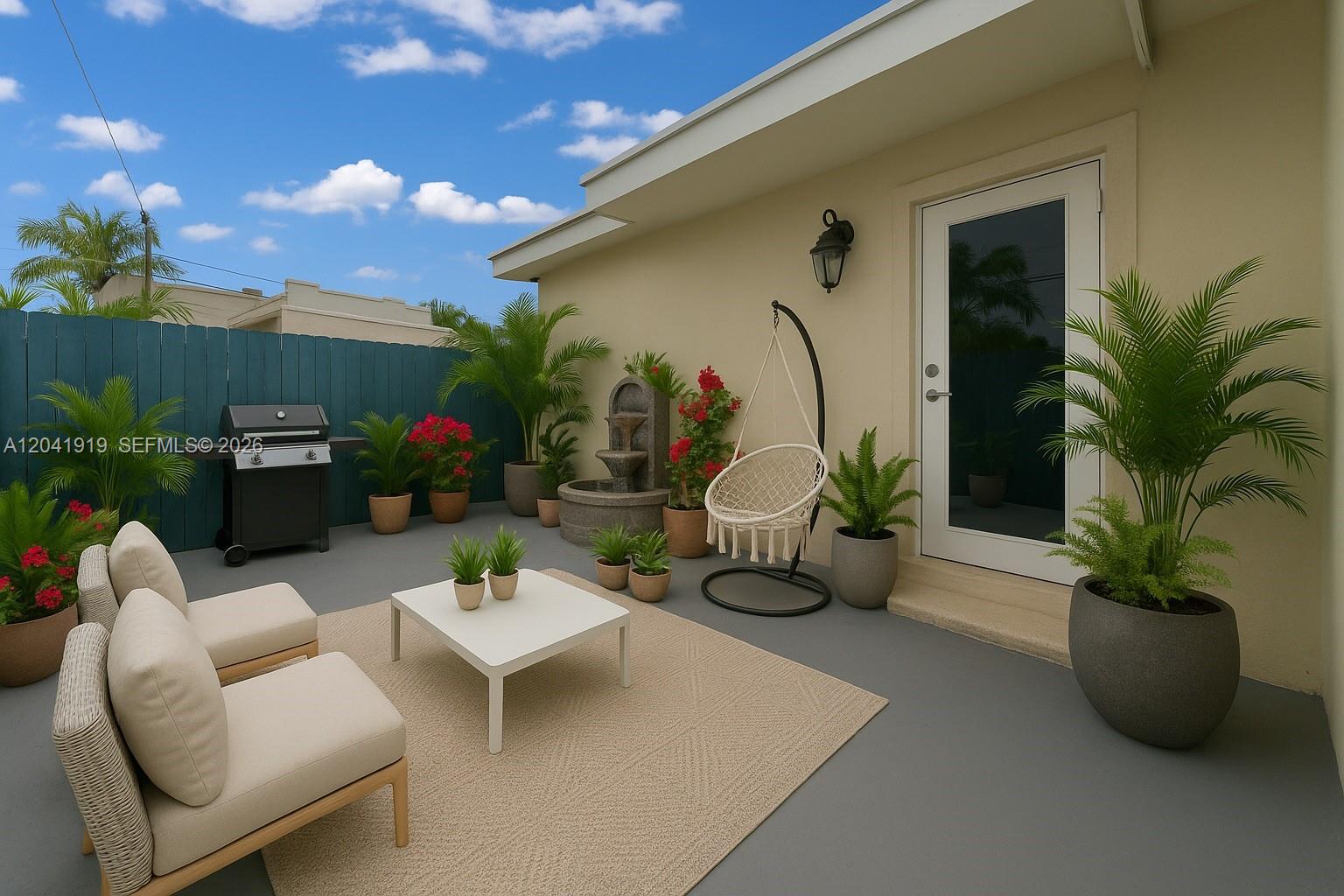 A patio features a seating area, a hanging chair, a fountain, and potted plants — 1701 NW 37th Ave # B, Miami FL 33125, MIAMI, FL