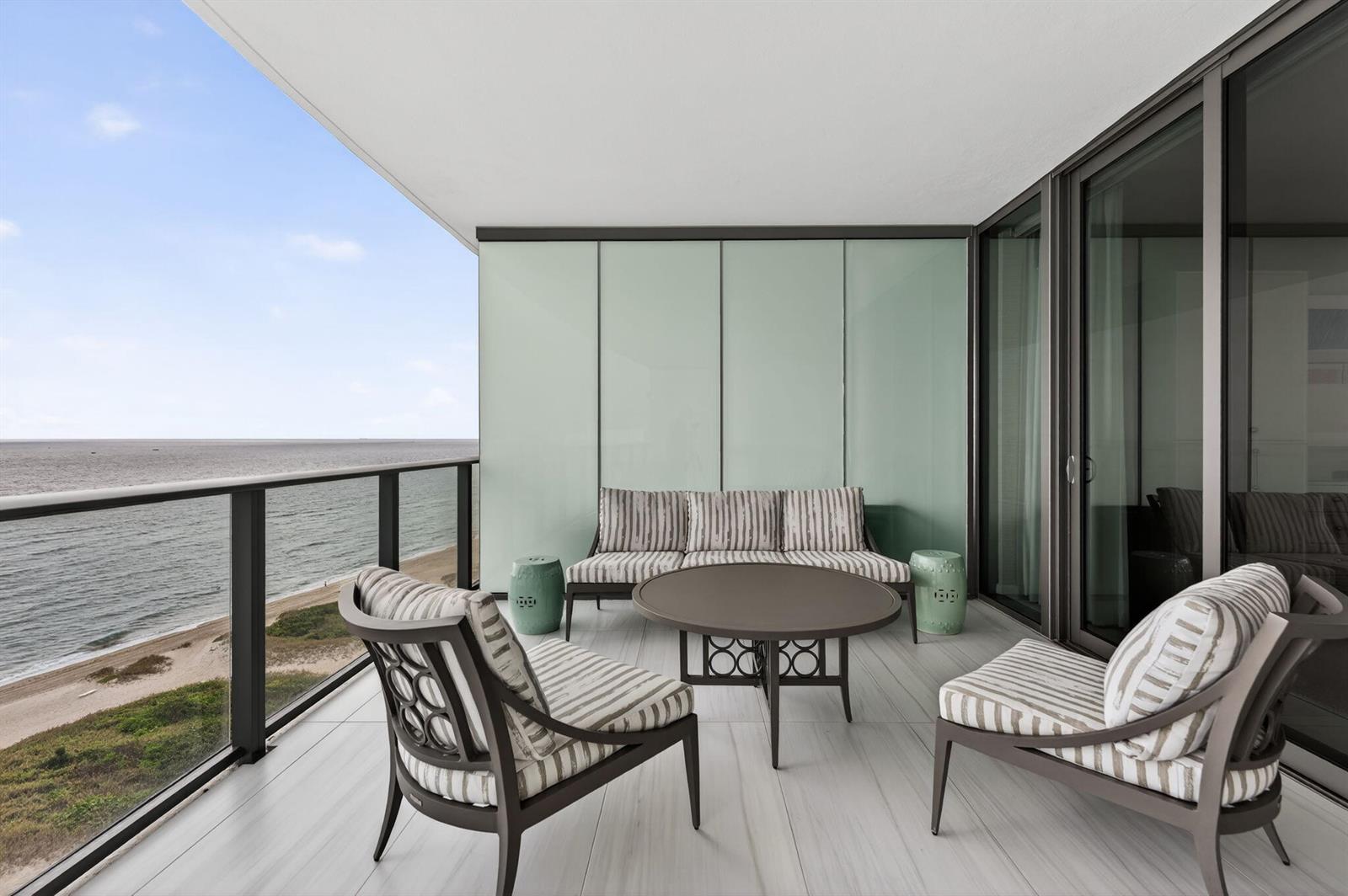 A balcony with outdoor furniture overlooks the ocean and a sandy beach — 1116 N Ocean Boulevard # 1204, Pompano Beach FL 33062, POMPANO BEACH, FL