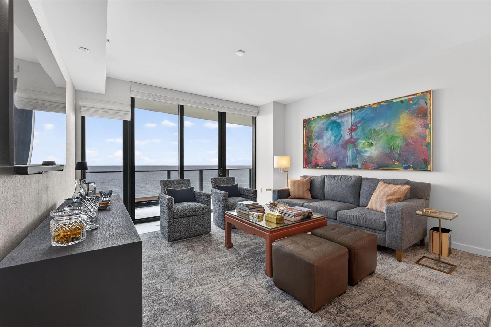 A living room with a grey sofa, two armchairs, and a large ocean-view window — 1116 N Ocean Boulevard # 1204, Pompano Beach FL 33062, POMPANO BEACH, FL