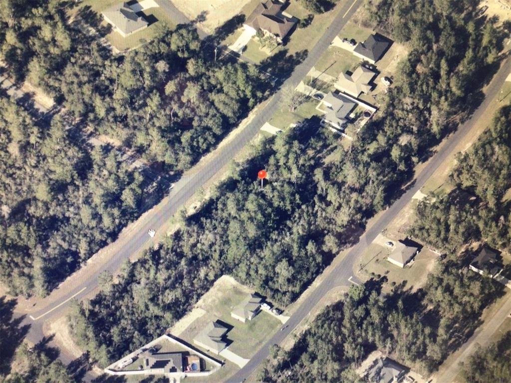 An aerial view shows a wooded, undeveloped lot marked with a red pin — 0 SW 169 PLACE, OCALA, FL