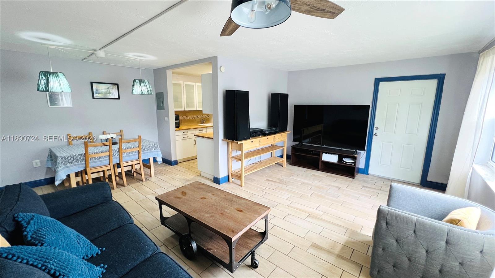 A living room with tile flooring, a dining area, and an open kitchen — 801 Meridian Ave # 1A, Miami Beach FL 33139, MIAMI BEACH, FL