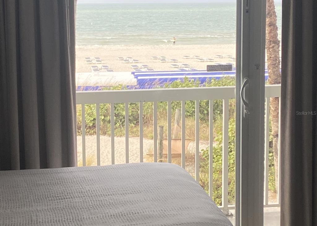 A view from a bedroom through a sliding glass door looking out toward the beach — 5500 GULF BOULEVARD UNIT 3219, ST PETE BEACH, FL