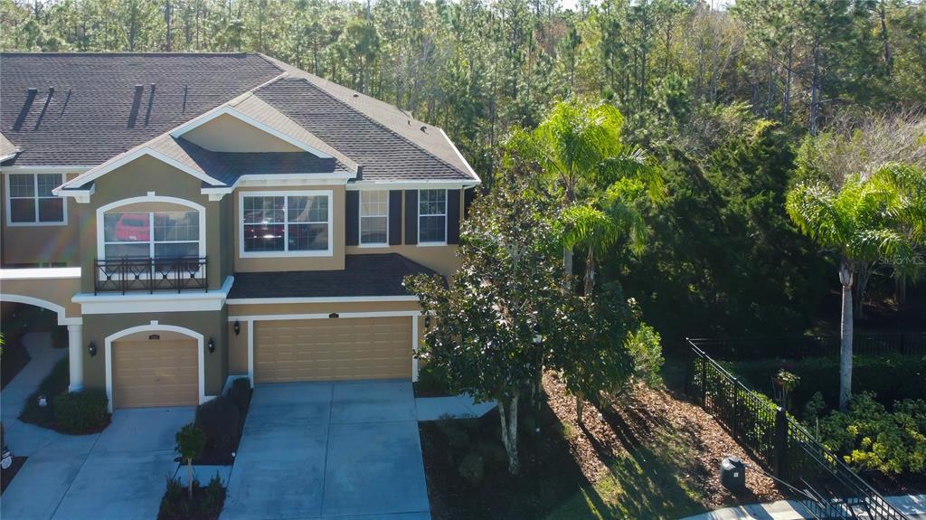 An aerial view of a two-story suburban house with a garage and palm trees — 12507 SILVERDALE STREET, TAMPA, FL