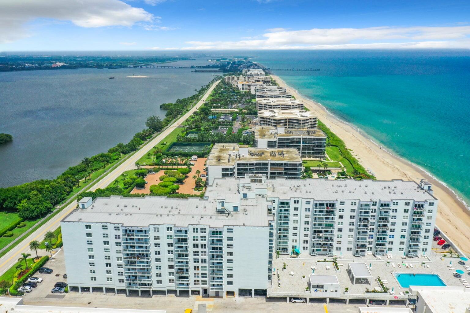Aerial view of a coastal condominium complex situated on a narrow strip of land — 3450 S Ocean Boulevard # 726, Palm Beach FL 33480, PALM BEACH, FL
