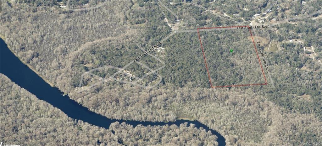 An aerial view shows a rectangular plot of land outlined in red near a river — 12683 E TRAILS END ROAD, FLORAL CITY, FL