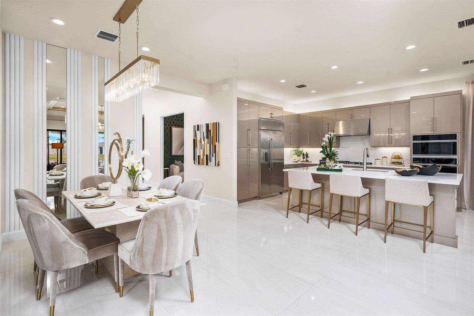 A modern open-concept kitchen and dining area featuring glossy cabinets, stone countertops, and tile flooring — 9123 Red Robin Lane, Boynton Beach FL 33473, BOYNTON BEACH, FL