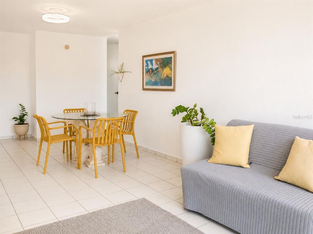 A living and dining area features white tile floors, yellow chairs, and a gray sofa — BOULEVARD DEL RIO II, GUAYNABO, PR