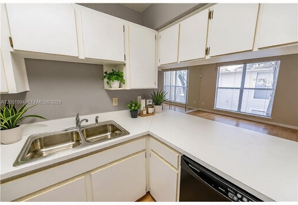 A kitchen features white cabinets, a double-basin stainless steel sink, and a white countertop — 606 S Albany Ave # 0, Tampa FL 33606, TAMPA, FL
