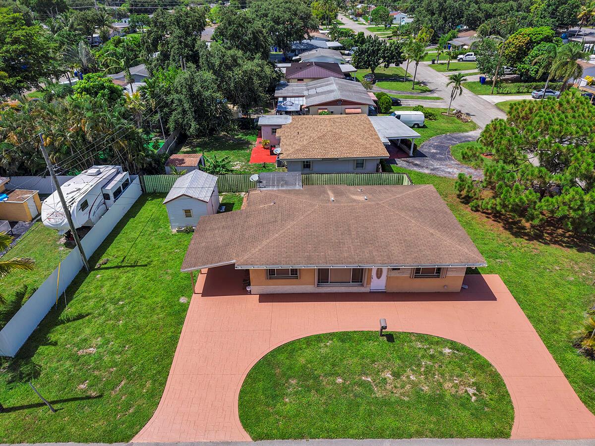An aerial view shows a single-story house with a brown roof and a circular driveway — 2100 N 57TH Avenue, Hollywood FL 33021, HOLLYWOOD, FL