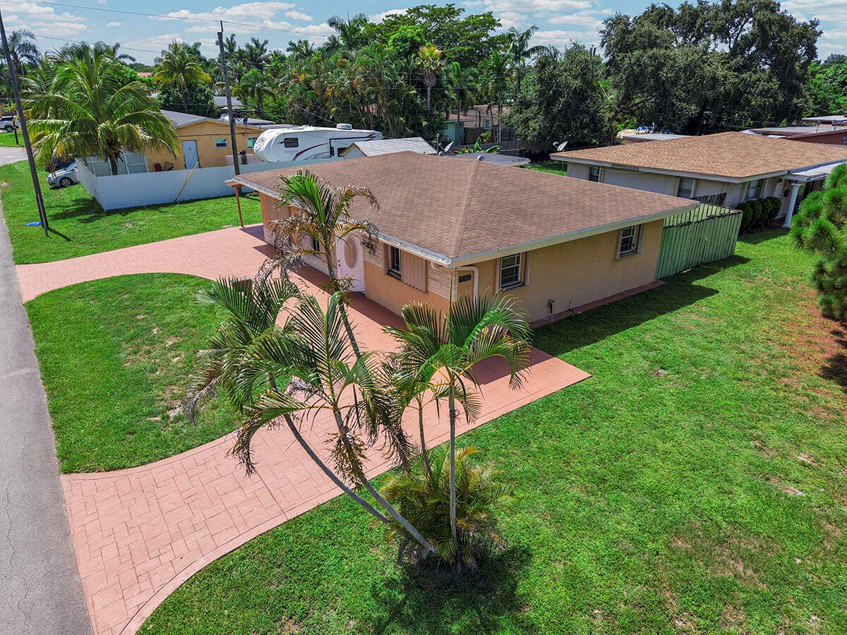 An aerial view of a single-story tan house with a brown roof and paved driveway — 2100 N 57TH Avenue, Hollywood FL 33021, HOLLYWOOD, FL
