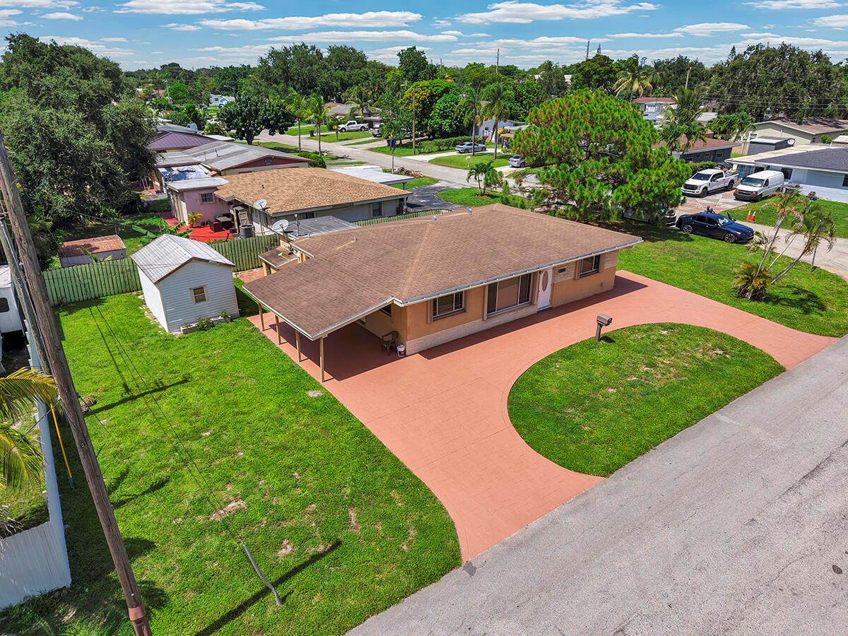 An aerial view of a single-story house with a brown roof and a painted driveway — 2100 N 57TH Avenue, Hollywood FL 33021, HOLLYWOOD, FL