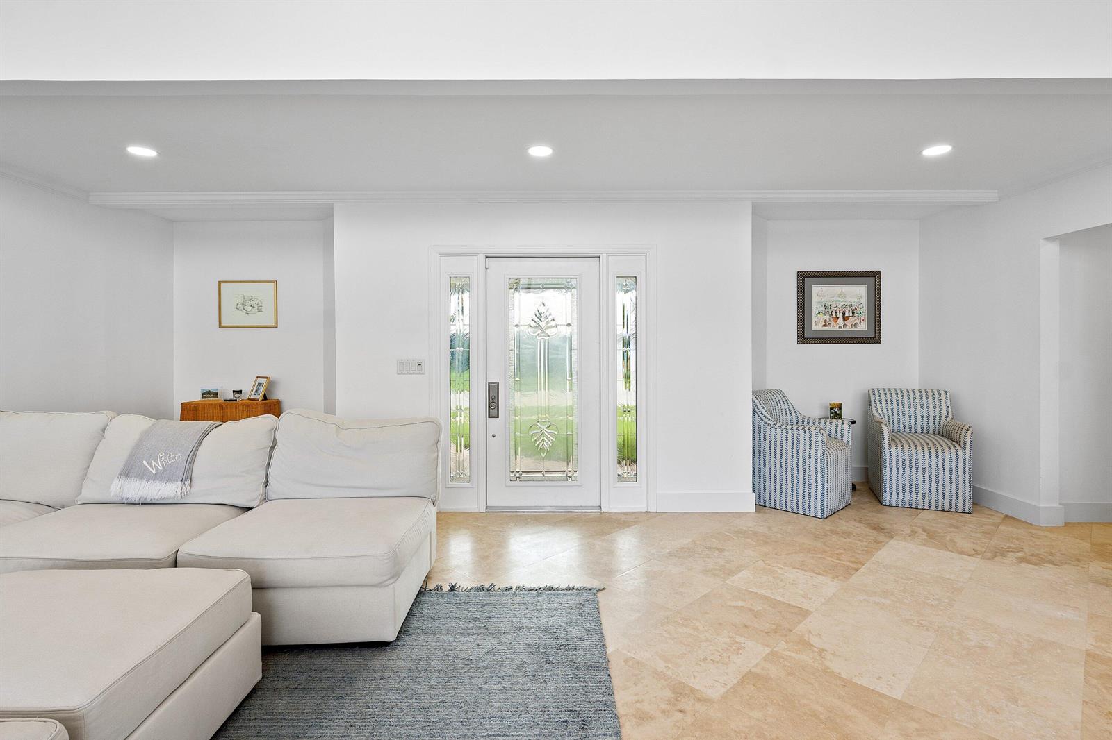 A living room features white walls, tile flooring, a sectional sofa, and a front entryway — 1332 SW Tamarind Way, Boca Raton FL 33486, BOCA RATON, FL
