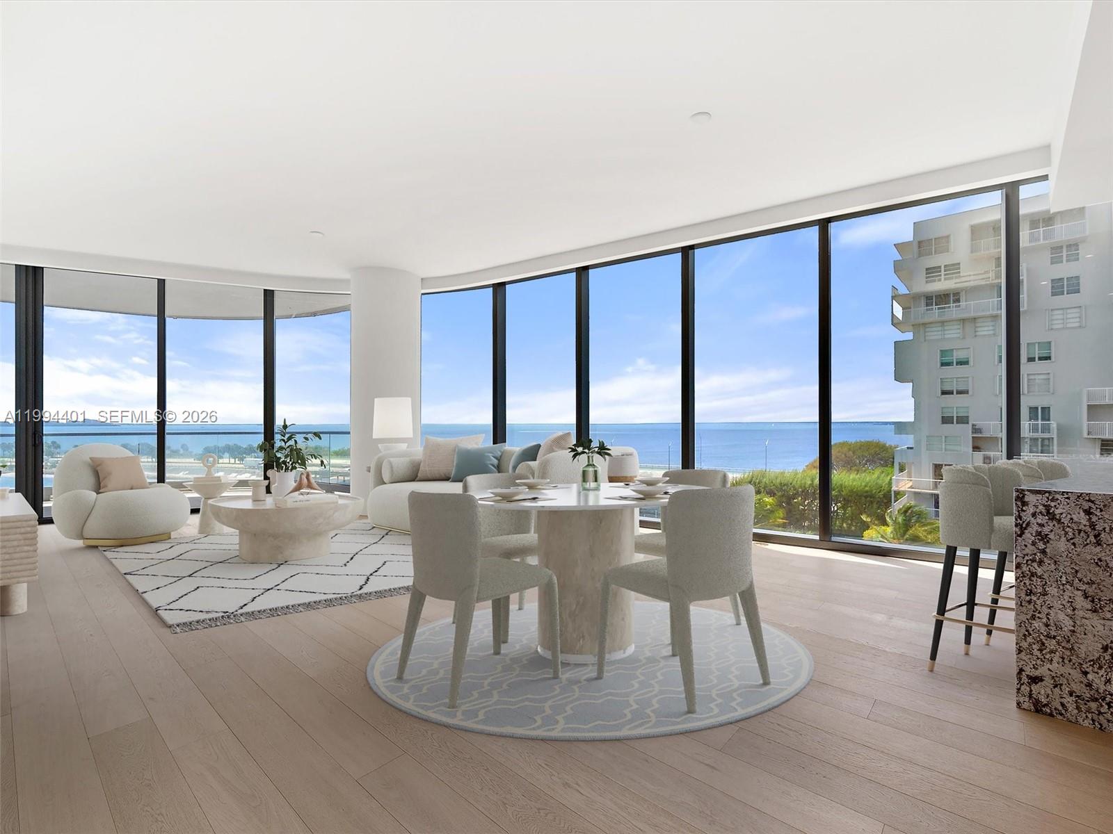 This living and dining area features floor-to-ceiling windows with ocean views and light wood flooring — 175 SE 25th Rd # 502, Miami FL 33129, MIAMI, FL
