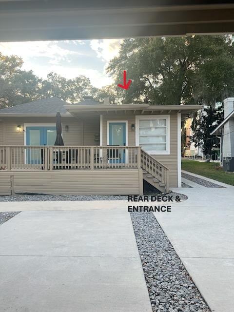A tan house features a rear deck with stairs and a light blue door — 541 MARGARET COURT, ORLANDO, FL