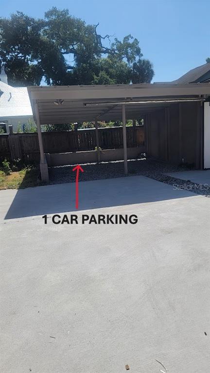 A covered carport with a concrete floor and a low retaining wall — 541 MARGARET COURT, ORLANDO, FL