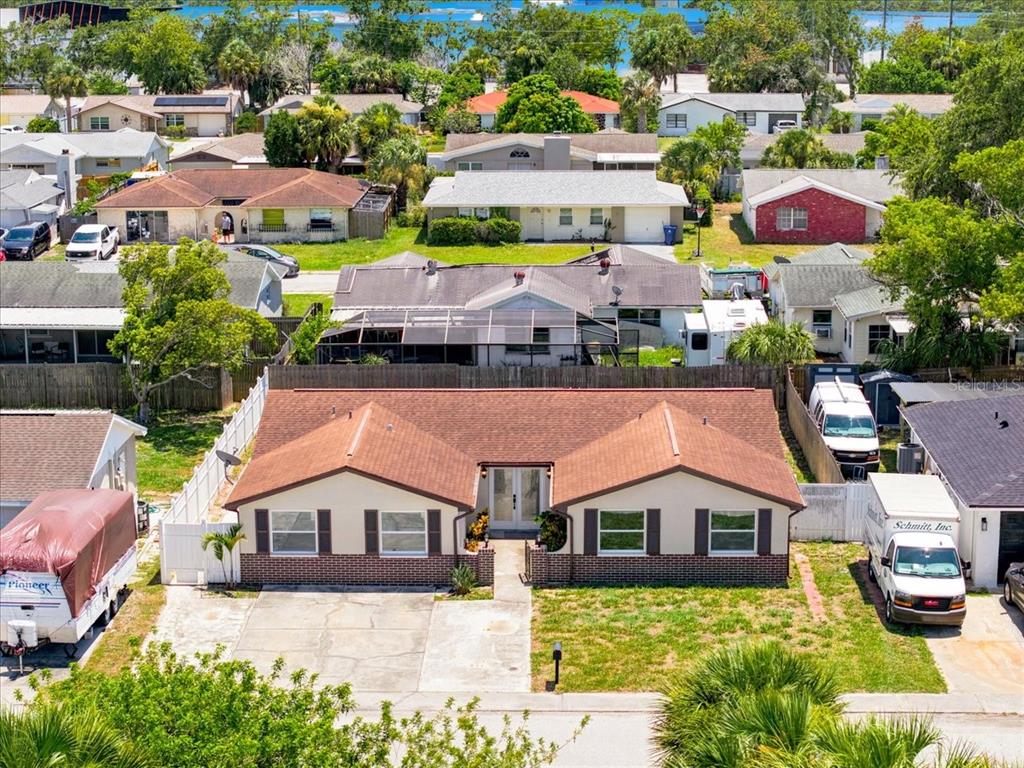 An aerial view shows a single-story house with a brown roof and a brick facade — 6224 KELLER DRIVE, PORT RICHEY, FL