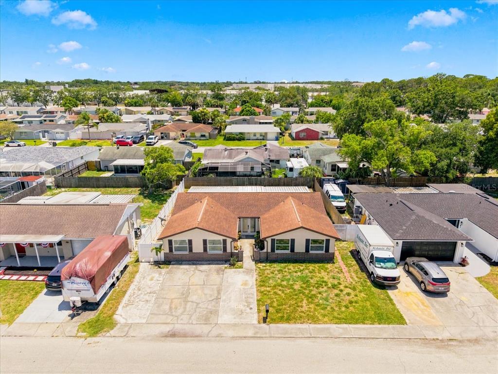 An aerial view shows a single-story house with a brown roof and a concrete driveway — 6224 KELLER DRIVE, PORT RICHEY, FL